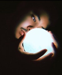 a man holding a crystal ball in his hand